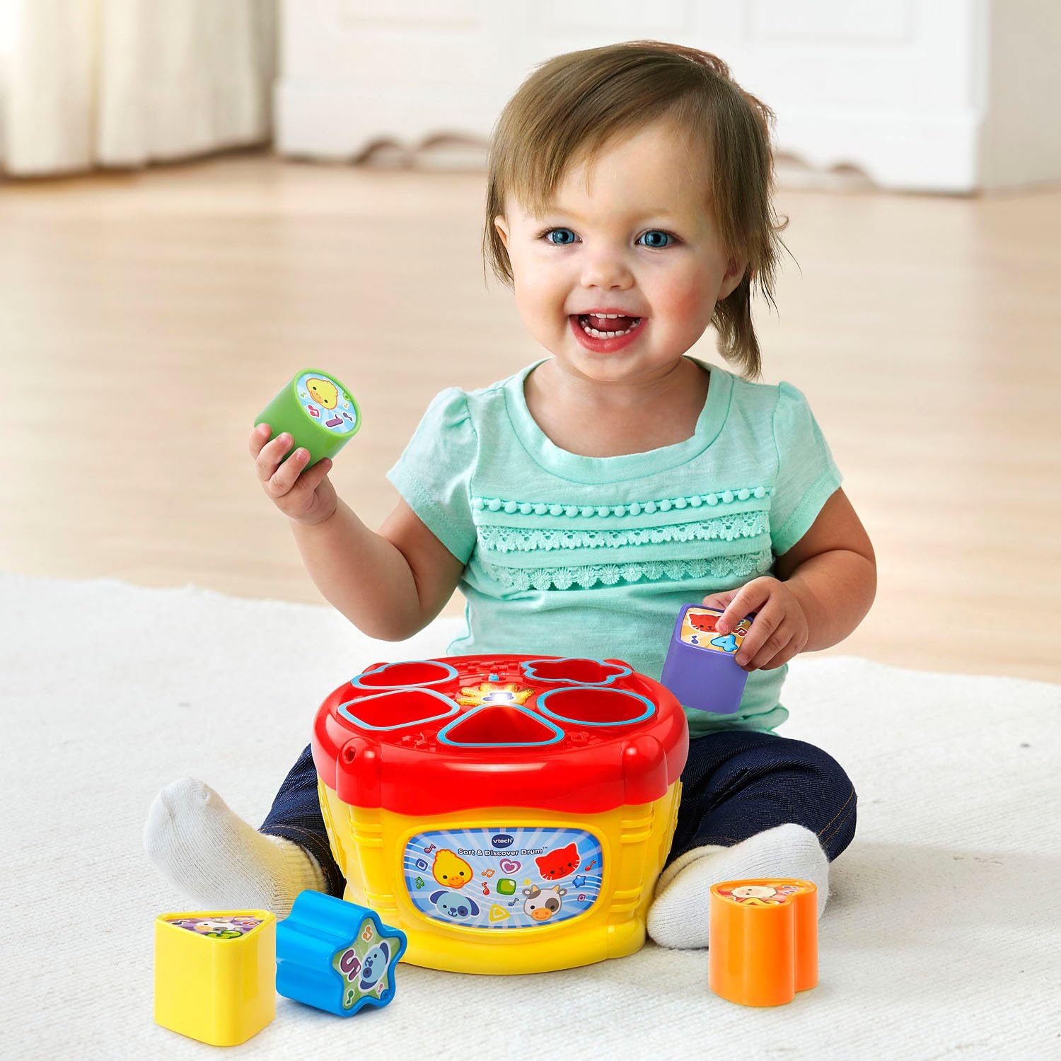 Child playing with Vtech - Sort & Discover Drum